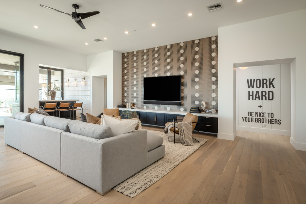 Design ideas for a large traditional open plan living room in Phoenix with a home bar, white walls, light hardwood flooring, no fireplace, a wall mounted tv, beige floors, a drop ceiling and wallpapered walls.