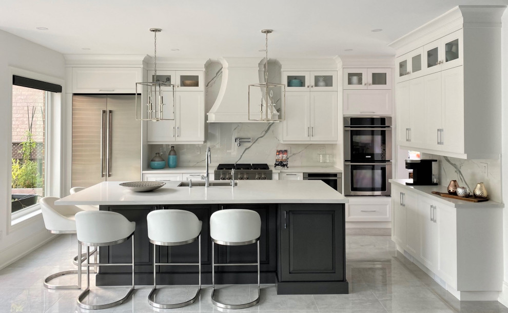 Inspiration for a large transitional l-shaped porcelain tile and white floor open concept kitchen remodel in Toronto with an undermount sink, recessed-panel cabinets, white cabinets, quartz countertops, white backsplash, stone slab backsplash, stainless steel appliances, an island and white countertops
