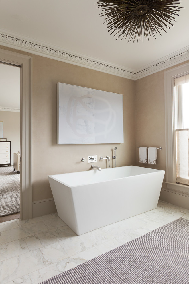 Transitional bathroom in San Francisco with a freestanding tub and beige walls.