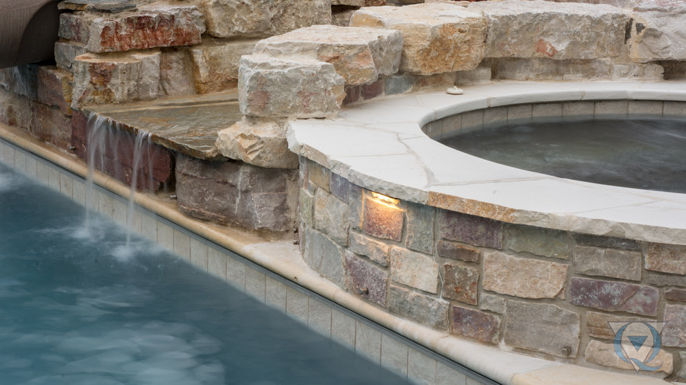 Large mountain style backyard rectangular lap water slide photo in Chicago