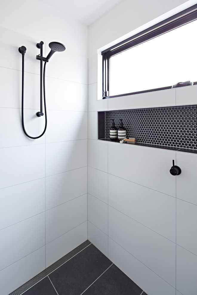 Photo of a mid-sized modern 3/4 bathroom in Melbourne with green cabinets, an open shower, white tile, white walls, a vessel sink, grey floor, an open shower, white benchtops, furniture-like cabinets, porcelain tile and engineered quartz benchtops.
