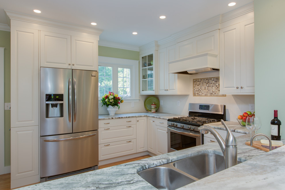 Inspiration for a transitional u-shaped medium tone wood floor eat-in kitchen remodel in Boston with an undermount sink, raised-panel cabinets, white cabinets, granite countertops, white backsplash, subway tile backsplash and stainless steel appliances