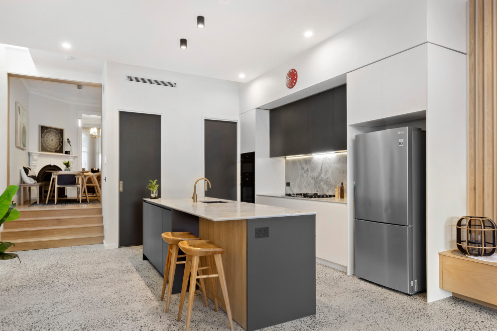 Scandinavian kitchen in Sydney with marble benchtops, marble splashback, concrete floors and with island.