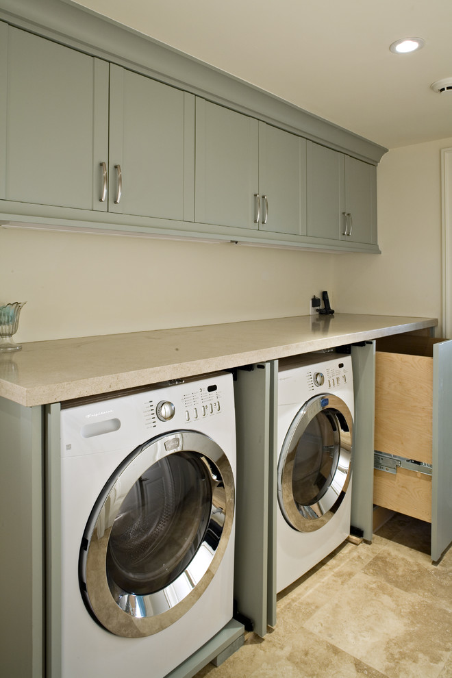 Design ideas for a transitional laundry room in Other with limestone benchtops, limestone floors and grey cabinets.