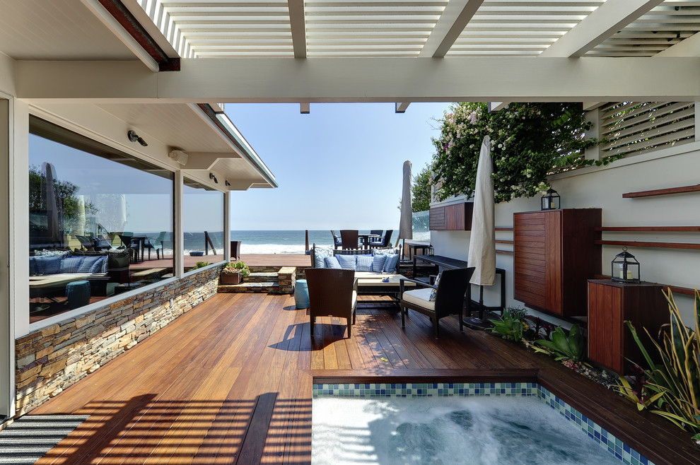 Beach style deck in Los Angeles with a pergola.