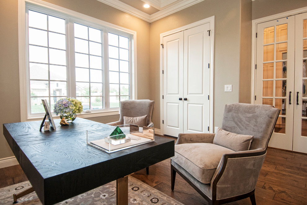 This is an example of a mid-sized transitional home office in Austin with grey walls, dark hardwood floors, a freestanding desk and brown floor.