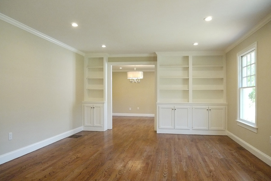 Inspiration for a mid-sized transitional enclosed family room in Boston with beige walls and medium hardwood floors.