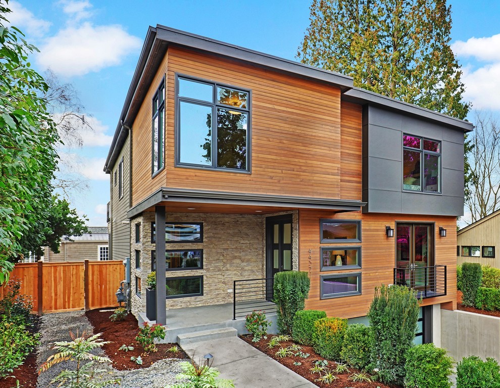 Contemporary three-storey grey exterior in Seattle with mixed siding and a flat roof.