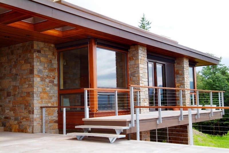 Large contemporary two-storey brown exterior in Seattle with mixed siding and a flat roof.