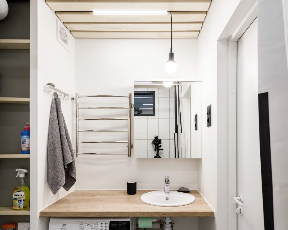 Inspiration for a small contemporary master bathroom with open cabinets, an undermount tub, a one-piece toilet, white tile, ceramic tile, grey walls, ceramic floors, an undermount sink, laminate benchtops, grey floor and brown benchtops.