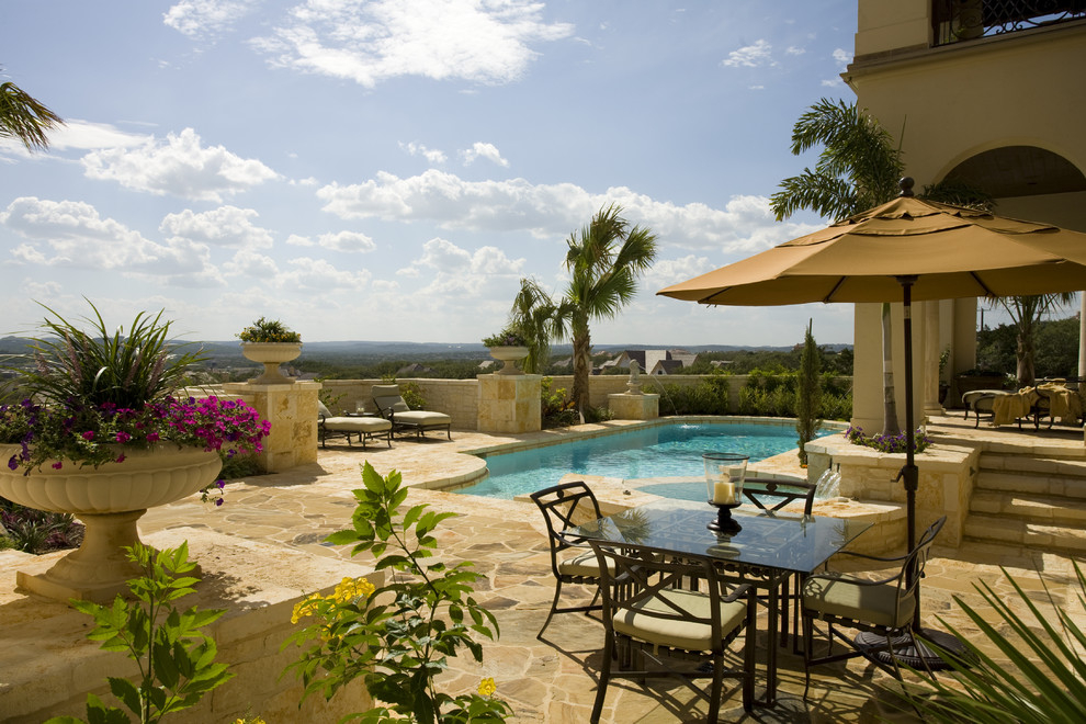 Inspiration for a mediterranean custom-shaped pool in Austin with natural stone pavers.