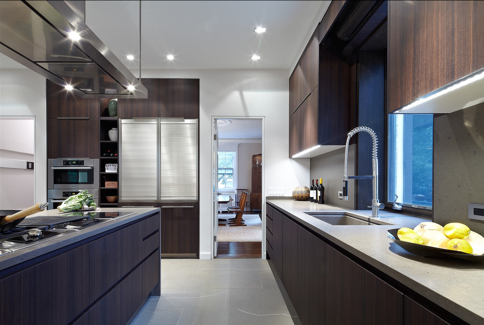 Photo of a contemporary l-shaped eat-in kitchen in DC Metro with an integrated sink, flat-panel cabinets, dark wood cabinets, quartz benchtops, brown splashback, stone slab splashback and stainless steel appliances.