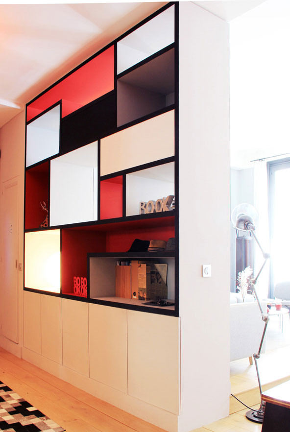 Photo of a small contemporary foyer in Paris with red walls and light hardwood floors.