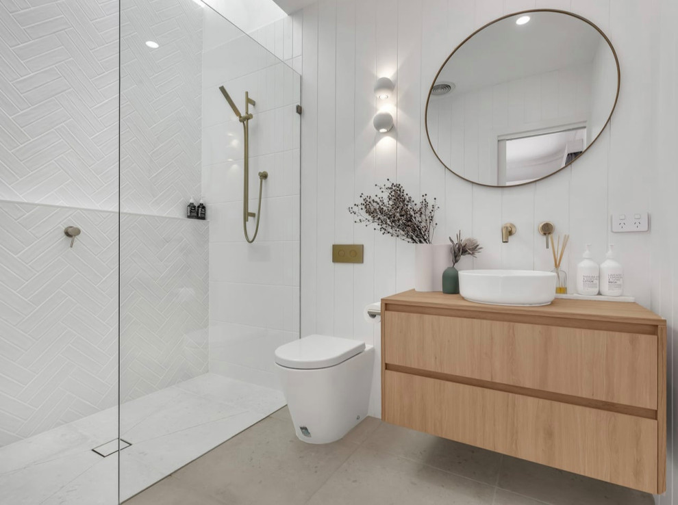 Small traditional master bathroom in Melbourne with flat-panel cabinets, light wood cabinets, an open shower, a wall-mount toilet, white tile, ceramic tile, white walls, terrazzo floors, wood benchtops, an open shower, brown benchtops, a niche, a single vanity, a floating vanity and vaulted.