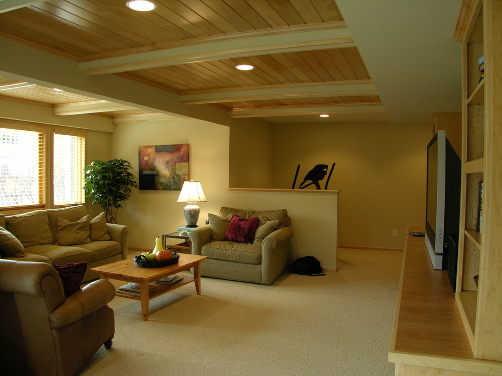 This is an example of a mid-sized traditional walk-out basement in Minneapolis with yellow walls, carpet, beige floor and no fireplace.