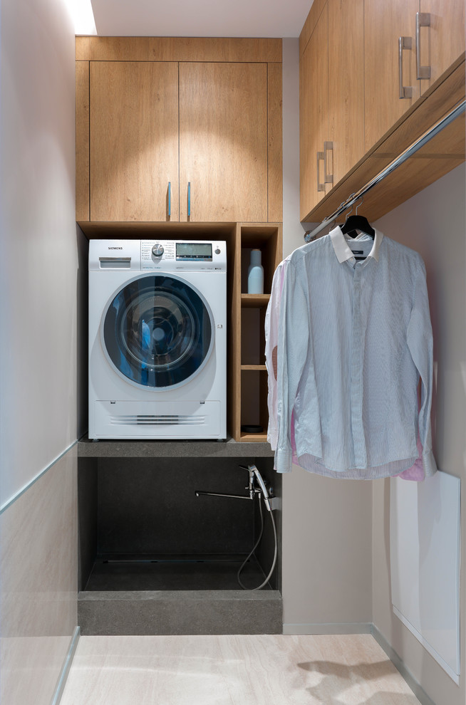 This is an example of a mid-sized contemporary dedicated laundry room in Other with flat-panel cabinets, medium wood cabinets and beige floor.