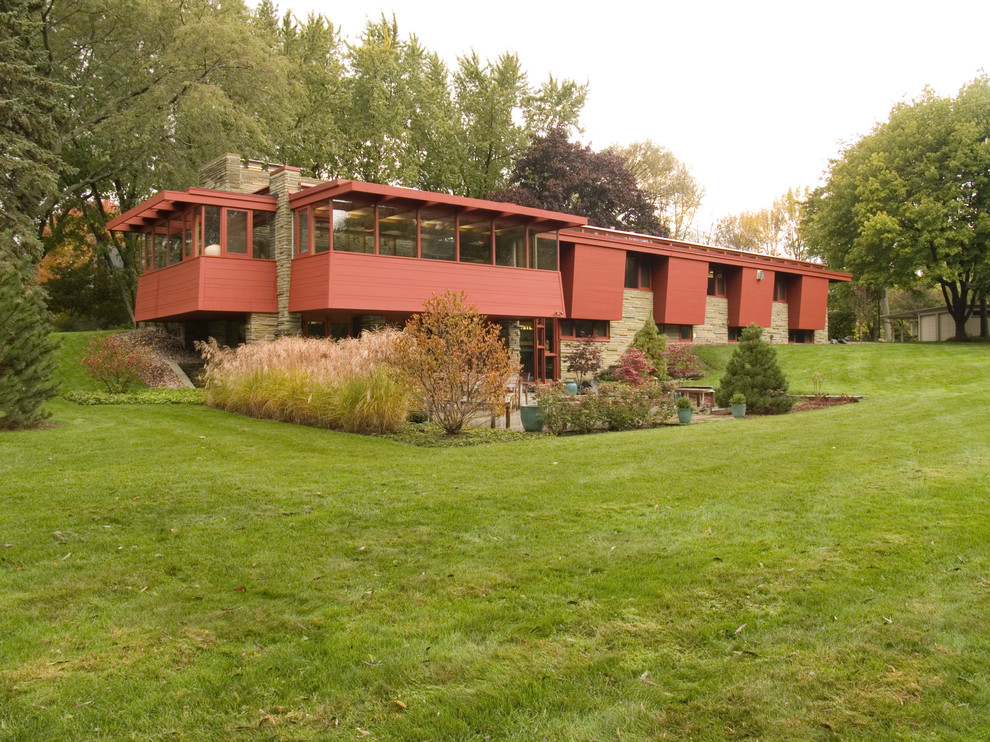 Midcentury split-level red exterior in Milwaukee with a flat roof.