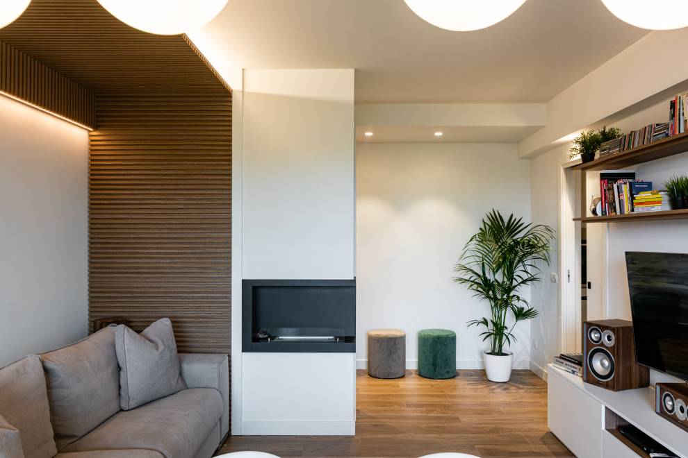 Mid-sized contemporary formal enclosed living room in Milan with white walls, porcelain floors, a standard fireplace, a metal fireplace surround, a built-in media wall, brown floor, timber and decorative wall panelling.