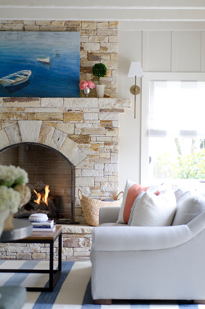 Mid-sized beach style light wood floor and gray floor family room photo in San Francisco with beige walls, a standard fireplace and a stone fireplace