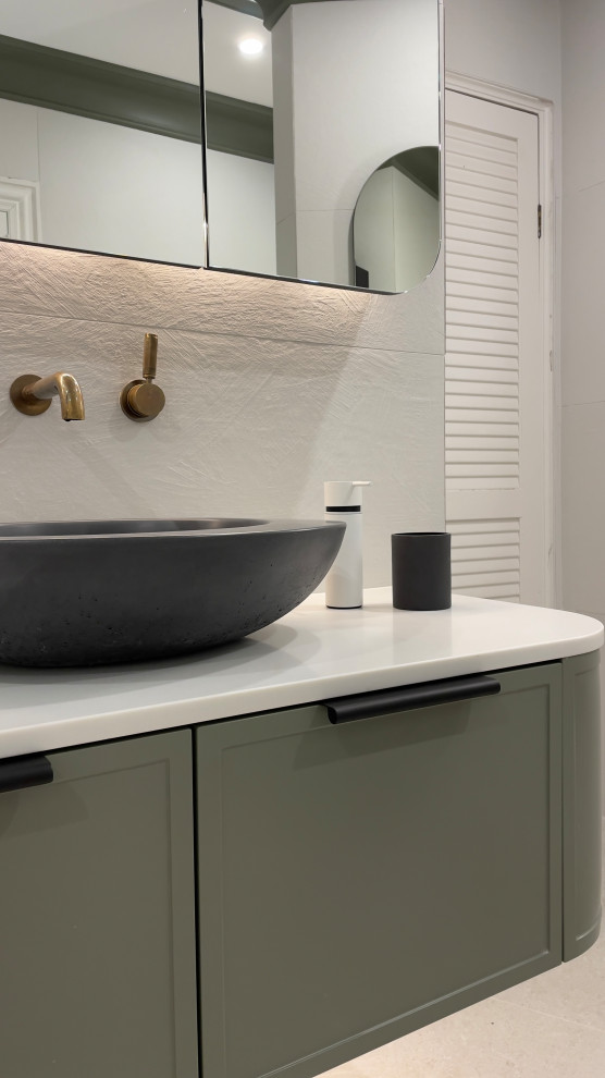 Large eclectic master bathroom in Sydney with shaker cabinets, green cabinets, an undermount tub, a shower/bathtub combo, a wall-mount toilet, white tile, porcelain tile, multi-coloured walls, porcelain floors, a vessel sink, engineered quartz benchtops, beige floor, a hinged shower door, white benchtops, a niche, a single vanity and a freestanding vanity.