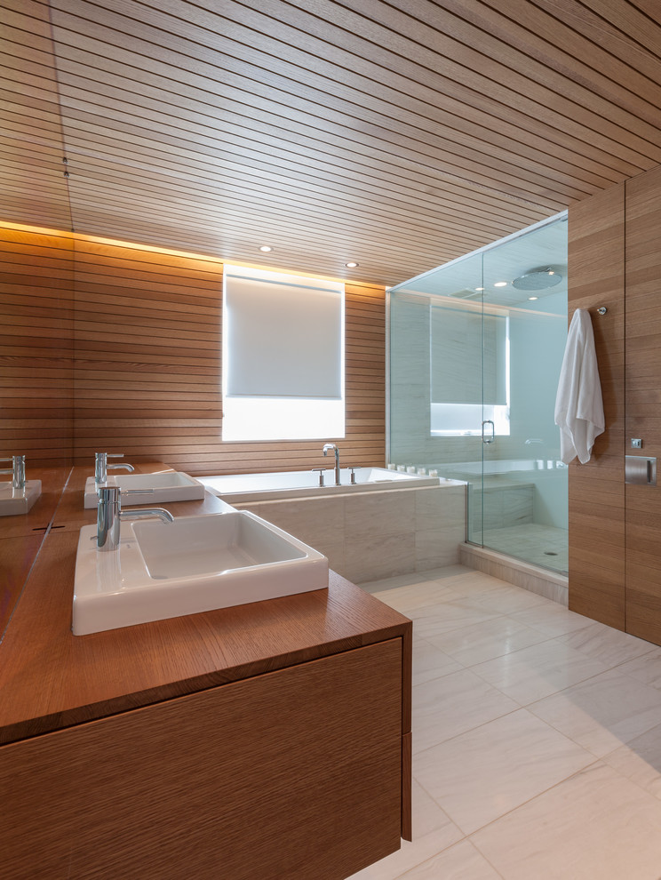 Inspiration for a large contemporary master wet room bathroom in Omaha with medium wood cabinets, a drop-in tub, brown walls, a drop-in sink, wood benchtops, white floor, a hinged shower door and brown benchtops.