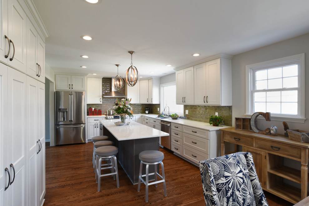 Large transitional l-shaped medium tone wood floor and brown floor eat-in kitchen photo in Orange County with a double-bowl sink, shaker cabinets, white cabinets, marble countertops, gray backsplash, glass tile backsplash, stainless steel appliances and an island
