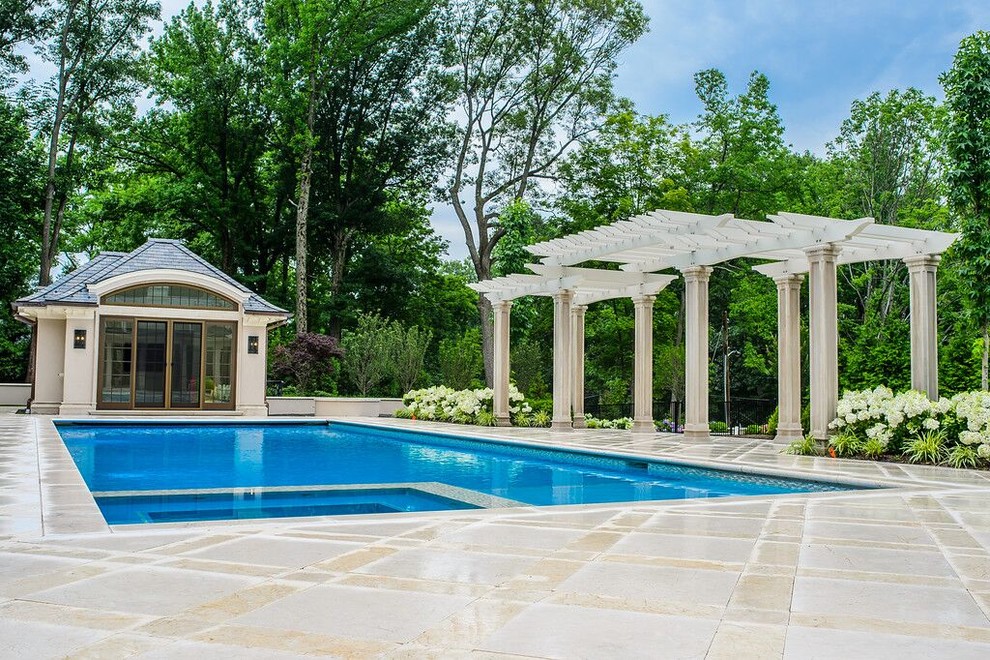Example of a large backyard stone and rectangular lap hot tub design in New York