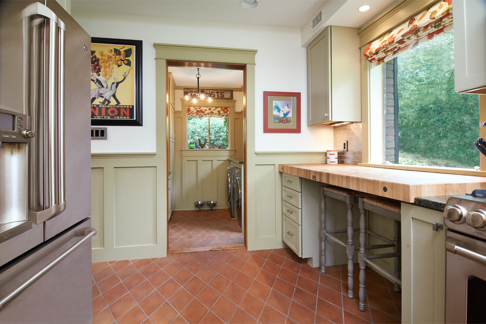 Inspiration for a small country u-shaped kitchen in Cleveland with a single-bowl sink, recessed-panel cabinets, granite benchtops, stainless steel appliances, terra-cotta floors, no island, green cabinets, metallic splashback, metal splashback and orange floor.