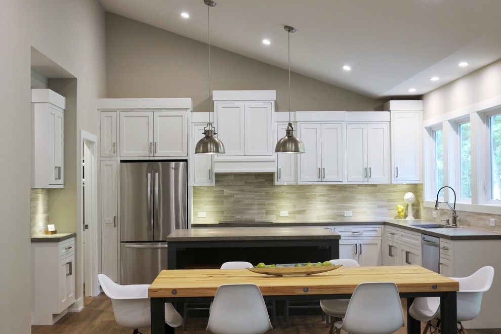 Large transitional l-shaped dark wood floor open concept kitchen photo in Grand Rapids with an undermount sink, shaker cabinets, white cabinets, quartz countertops, beige backsplash, porcelain backsplash, stainless steel appliances and an island
