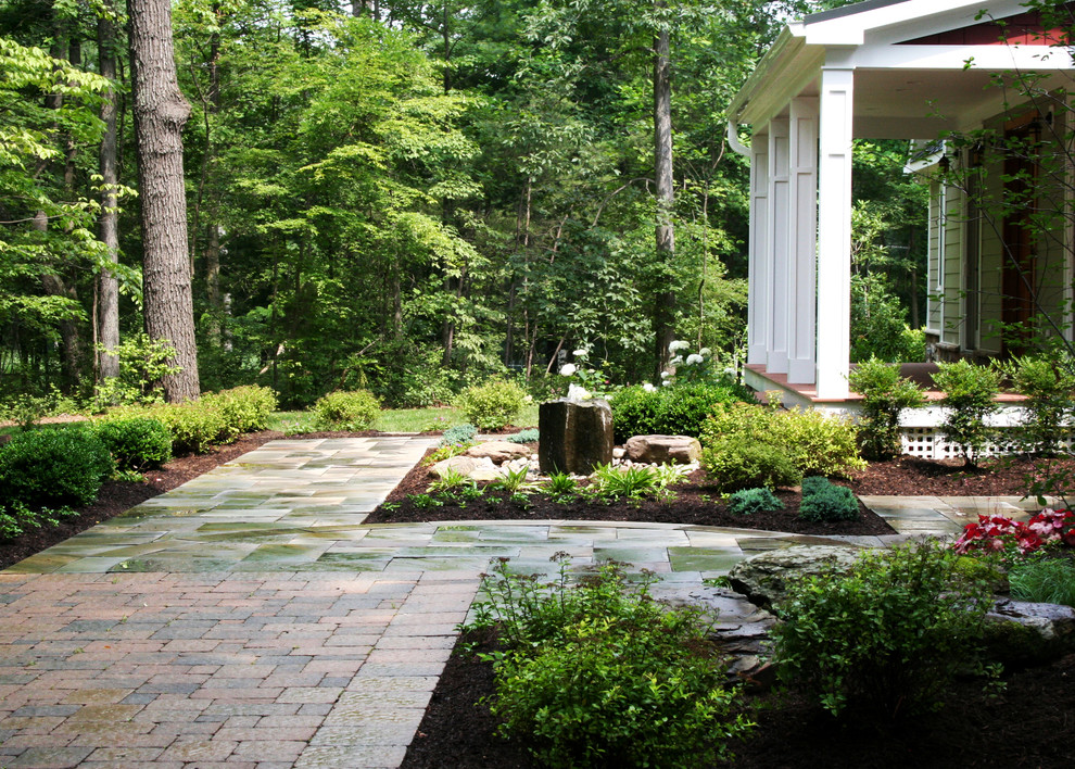 Inspiration for a country garden in DC Metro with a water feature and brick pavers.