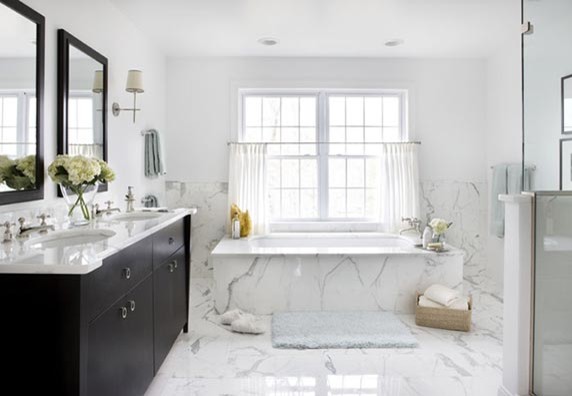 Design ideas for a mid-sized transitional master bathroom in New York with furniture-like cabinets, dark wood cabinets, a freestanding tub, a corner shower, a two-piece toilet, white tile, marble, white walls, marble floors, an undermount sink, marble benchtops, a hinged shower door and white benchtops.