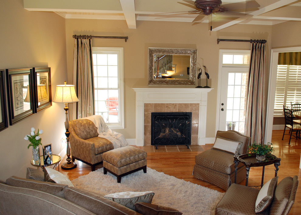 Mid-sized traditional enclosed living room in Other with beige walls, light hardwood floors and a standard fireplace.