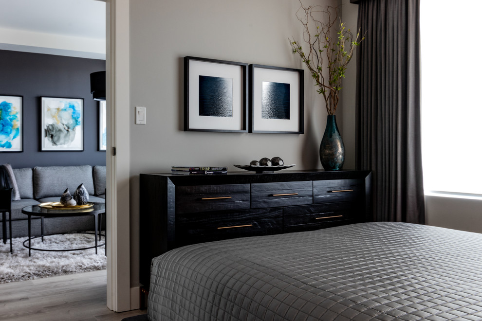 Photo of a small contemporary master bedroom in Vancouver with grey walls, light hardwood floors and grey floor.