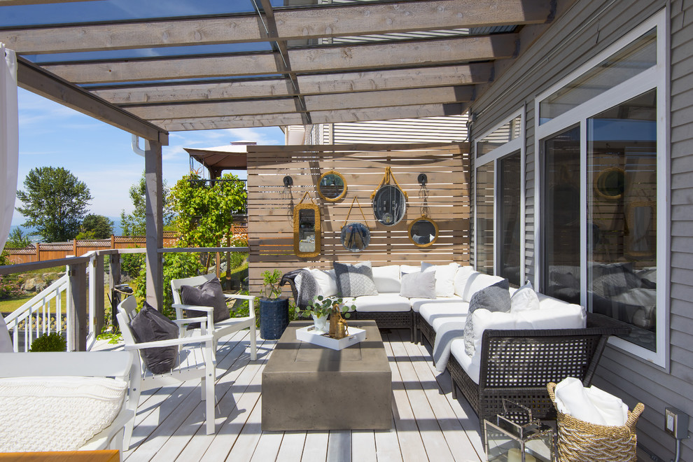 Large transitional backyard outdoor kitchen deck photo in Vancouver with a pergola