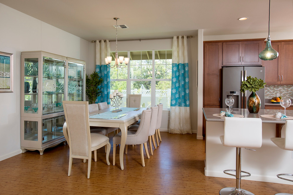 Small contemporary dining room in Hawaii with white walls and bamboo floors.