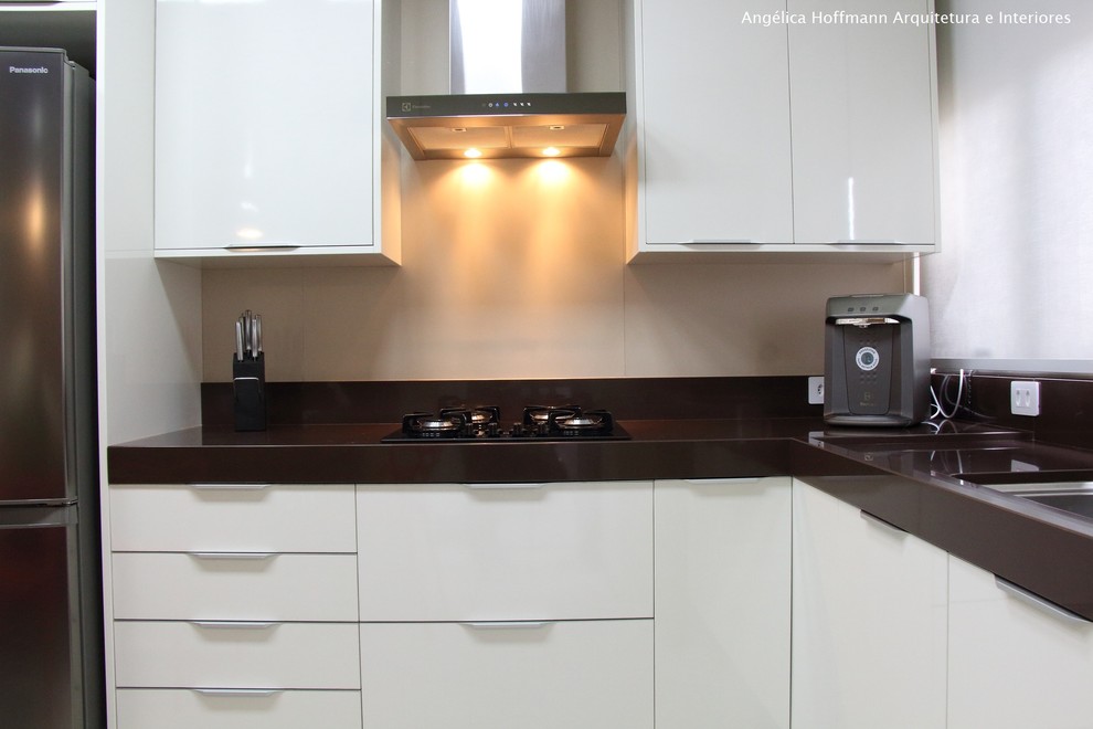 Mid-sized trendy u-shaped dark wood floor and gray floor eat-in kitchen photo with a drop-in sink, flat-panel cabinets, white cabinets, granite countertops, brown backsplash, window backsplash and stainless steel appliances