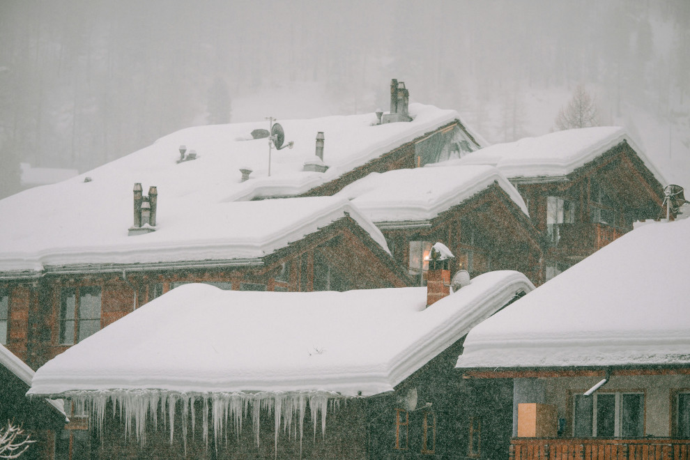 house rooftop from afar showing snow and ice build up