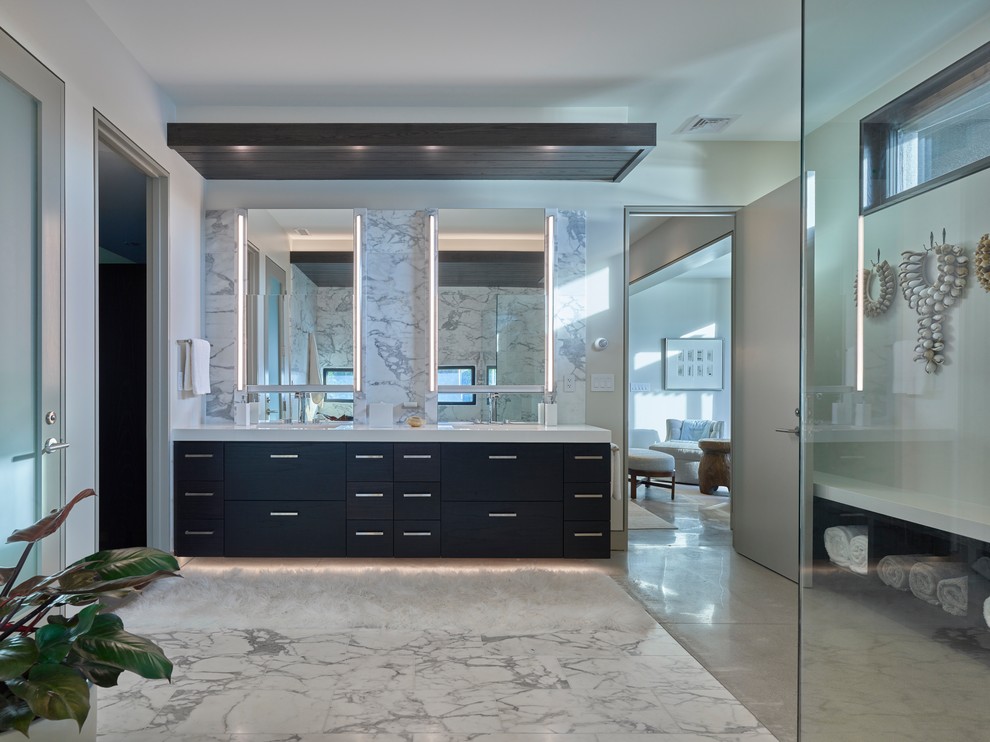 Large modern master bathroom in Other with flat-panel cabinets, black cabinets, white walls, white benchtops, a freestanding tub, a corner shower, an integrated sink, solid surface benchtops and a hinged shower door.