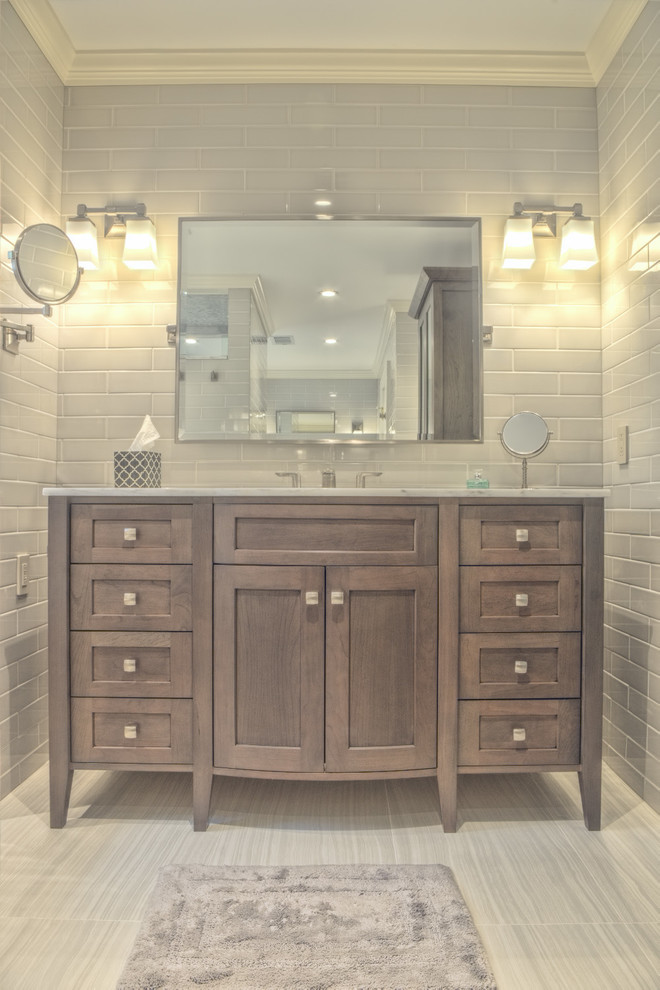 This is an example of a large transitional master bathroom in Atlanta with shaker cabinets, light wood cabinets, gray tile, subway tile, marble benchtops, a corner shower, grey walls, porcelain floors, an undermount sink and an undermount tub.