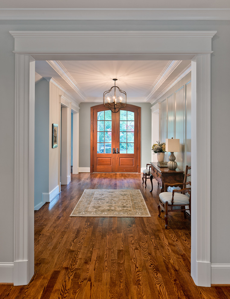 Design ideas for a large traditional foyer in DC Metro with dark hardwood floors, a double front door, a medium wood front door and grey walls.