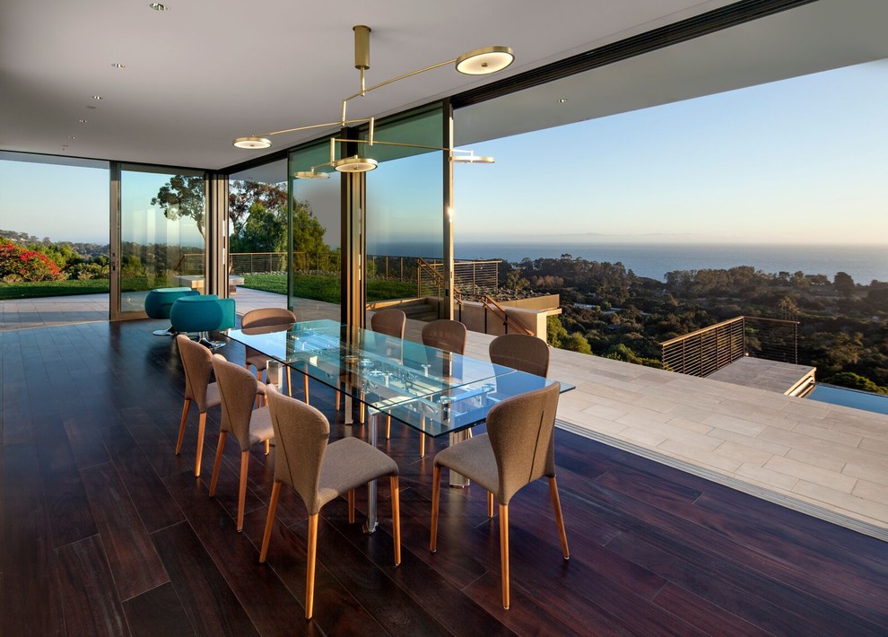 This is an example of a contemporary open plan dining in Santa Barbara with dark hardwood floors.