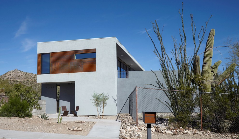 This is an example of a small modern two-storey grey house exterior in Phoenix with metal siding and a flat roof.