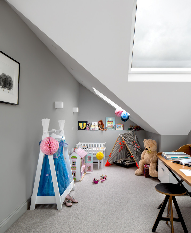 Scandinavian kids' room in London with grey walls, carpet and grey floor for girls.