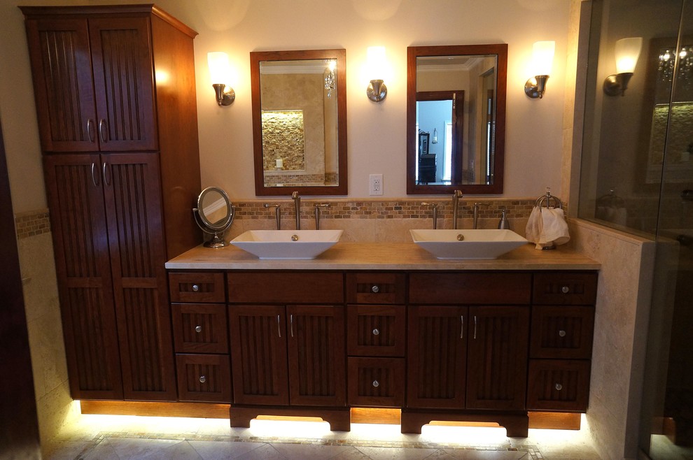 This is an example of a mid-sized traditional master bathroom in Philadelphia with louvered cabinets, dark wood cabinets, an alcove shower, beige tile, ceramic tile, white walls, ceramic floors, a vessel sink and quartzite benchtops.
