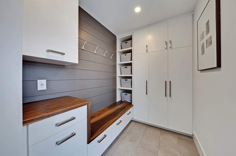 Photo of a mid-sized transitional mudroom in Calgary with white walls, ceramic floors, a single front door, a white front door and grey floor.