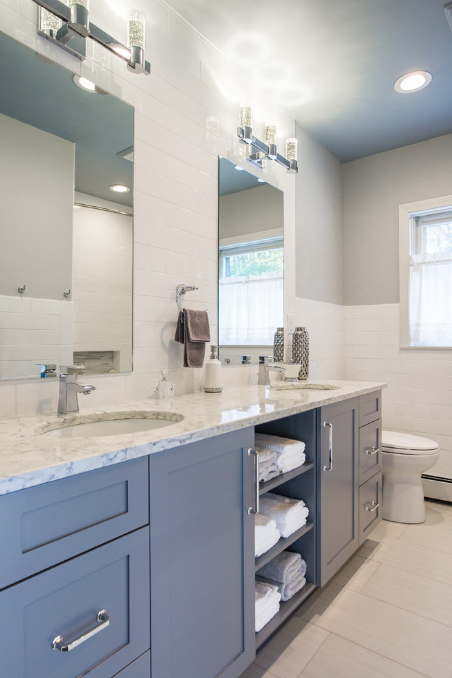 Design ideas for a mid-sized transitional bathroom in Boston with an undermount sink, grey cabinets, engineered quartz benchtops, white tile, ceramic tile, grey walls, porcelain floors and shaker cabinets.