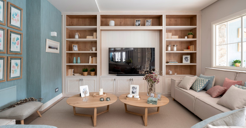 Design ideas for a large scandinavian open concept living room in Bilbao with a library, blue walls, laminate floors, no fireplace, a built-in media wall and brown floor.