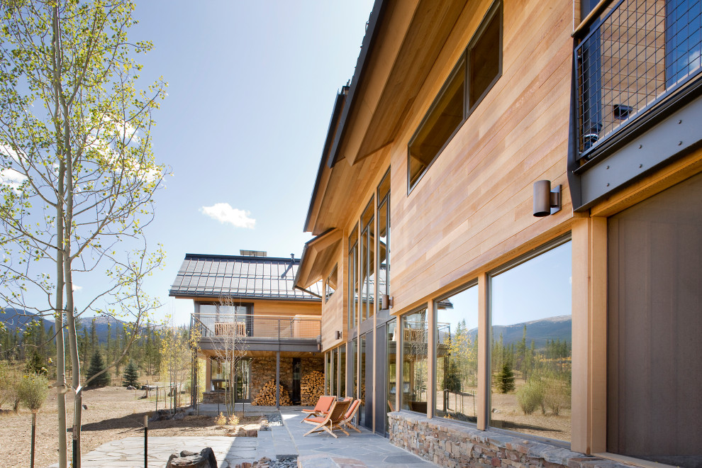 Large minimalist brown two-story mixed siding gable roof photo in Denver