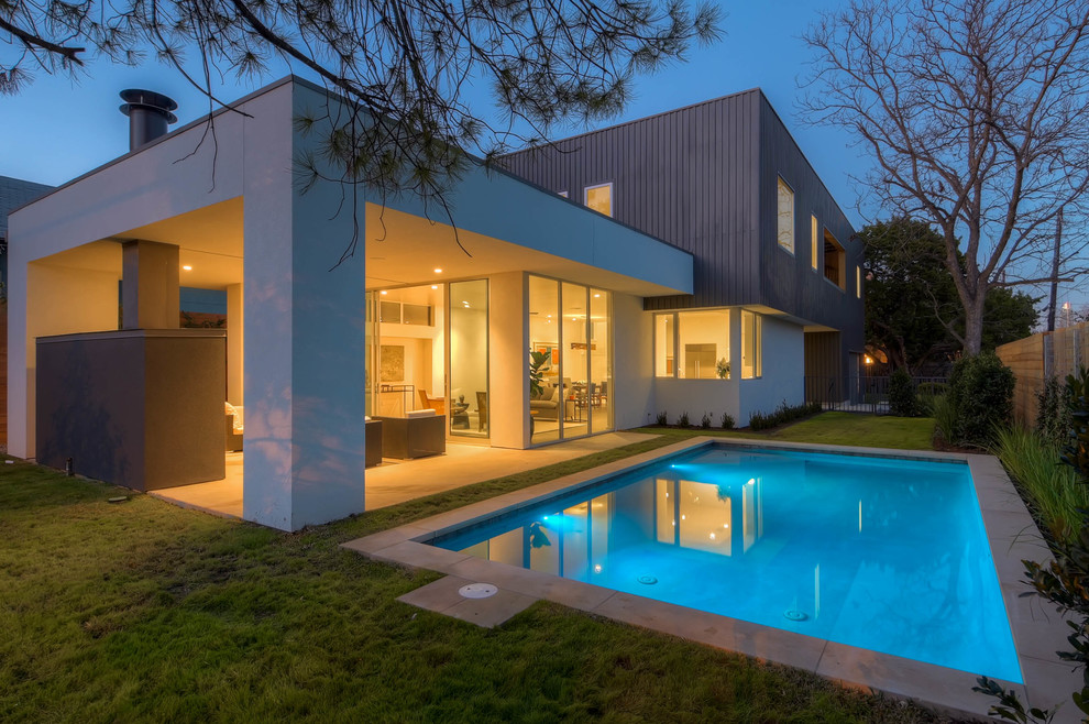 Example of a mid-sized minimalist backyard concrete and rectangular lap pool house design in Austin