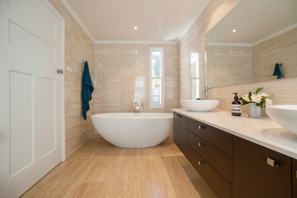 Design ideas for a small contemporary master bathroom in Melbourne with a vessel sink, flat-panel cabinets, dark wood cabinets, marble benchtops, a freestanding tub, an open shower, beige tile, porcelain tile, beige walls and porcelain floors.